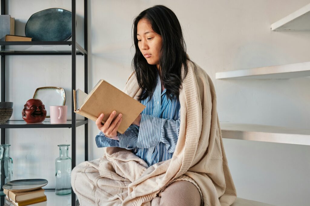 woman at home wrapped in blanket